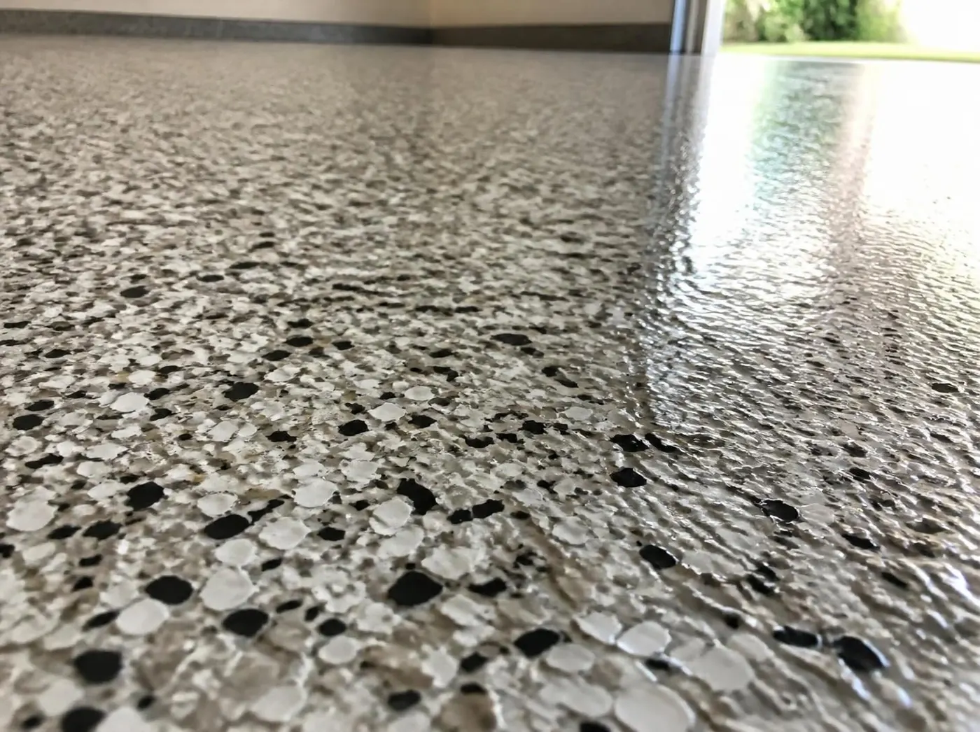 Close-up of a gray and tan flake epoxy garage floor