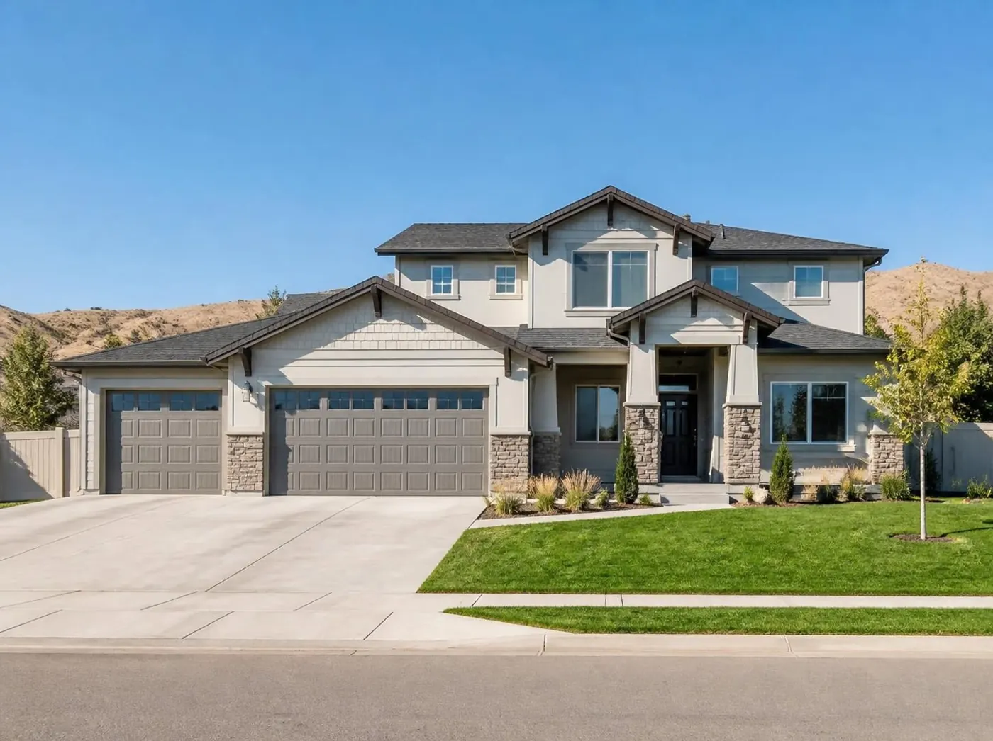 Two-story Treasure Valley home with a three-car garage and foothills in the background